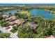 Aerial view of home with a pool, surrounded by lush landscaping and a lake at 2309 Chardonnay Ter, Parrish, FL 34219