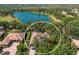 Aerial view of home nestled among trees, overlooking a serene lake at 2309 Chardonnay Ter, Parrish, FL 34219