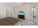 Cozy bedroom featuring neutral tones, ceiling fan, and access to the outdoor patio at 2309 Chardonnay Ter, Parrish, FL 34219