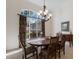 Formal dining room with a large window, elegant chandelier, and wood furniture at 2309 Chardonnay Ter, Parrish, FL 34219