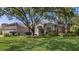 Charming single-story home with well-manicured front lawn, mature trees, and beautiful landscaping at 2309 Chardonnay Ter, Parrish, FL 34219