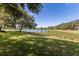 Beautiful lake view from the property, showcasing lush greenery and serene water at 2309 Chardonnay Ter, Parrish, FL 34219