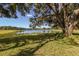 Picturesque lake view framed by mature trees draped with Spanish moss, enhancing the natural beauty at 2309 Chardonnay Ter, Parrish, FL 34219