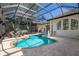 Beautiful screened-in pool area with comfortable lounge chairs and lush landscaping at 2309 Chardonnay Ter, Parrish, FL 34219