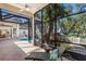 Inviting screened-in lanai featuring a pool with a slide, a lounge chair and well-manicured landscaping at 2309 Chardonnay Ter, Parrish, FL 34219