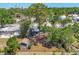 Aerial view of a cozy home with mature trees, a backyard patio, and a small shed adding to the property's charm at 2350 Novus St, Sarasota, FL 34237