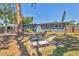 Relaxing backyard featuring a patio with lounge chairs and a well-maintained lawn, perfect for outdoor enjoyment at 2350 Novus St, Sarasota, FL 34237