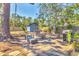 Backyard featuring a shed, outdoor seating, grill and green trees under a blue sky at 2350 Novus St, Sarasota, FL 34237