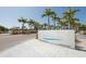 Entrance to Siesta Beach featuring a decorative sign, palm trees, and a glimpse of the inviting sandy shore at 2350 Novus St, Sarasota, FL 34237