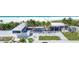 Beautiful beachside with palm trees, white sands, and a building featuring a Siesta Beach sign on a sunny day at 2350 Novus St, Sarasota, FL 34237