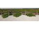 Picture of a path surrounded by lush beach vegetation and leading to a beach with white sand and blue water at 2350 Novus St, Sarasota, FL 34237