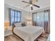Well-lit bedroom with a ceiling fan, neutral colors, and modern decor at 2350 Novus St, Sarasota, FL 34237