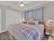 Comfortable bedroom with a decorative ceiling fan, neutral decor, and ample natural light at 2350 Novus St, Sarasota, FL 34237