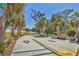 Scenic bike path lined with palm trees and lush greenery, perfect for recreation and outdoor activities at 2350 Novus St, Sarasota, FL 34237