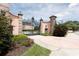 Landscaped entrance with an ornate black metal gate and pink stucco walls at 2350 Novus St, Sarasota, FL 34237