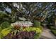 Marie Selby Botanical Gardens sign surrounded by colorful plants and foliage at 2350 Novus St, Sarasota, FL 34237