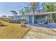 Charming single-story home with a covered front porch and landscaped yard at 2350 Novus St, Sarasota, FL 34237