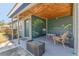 Charming front porch features a seating area, wood ceiling, and decorative garden art at 2350 Novus St, Sarasota, FL 34237