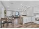 Open concept kitchen and living room area with new flooring, lighting fixtures, and appliances at 2350 Novus St, Sarasota, FL 34237