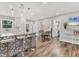 Bright, open-concept kitchen featuring modern appliances, stylish pendant lighting, and mosaic island at 2350 Novus St, Sarasota, FL 34237