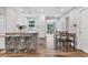 Bright open kitchen with bar seating, seamless access to dining and living areas at 2350 Novus St, Sarasota, FL 34237