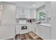 Clean kitchen featuring white cabinets, quartz countertops, and stainless steel appliances at 2350 Novus St, Sarasota, FL 34237