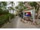 Picturesque view of a tiki bar entrance with tropical plants and a welcoming sign at 2350 Novus St, Sarasota, FL 34237