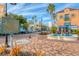 Charming town square with a water feature, dining area, and palm trees at 2350 Novus St, Sarasota, FL 34237