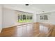 Sun-drenched living room with hardwood floors and large windows offering tranquil views at 3001 Bay Shore Cir, Sarasota, FL 34234