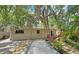Backyard with a bocce ball court, lush landscaping, and outdoor lighting at 3004 Bay Shore Cir, Sarasota, FL 34234