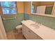 Bathroom featuring a vanity with chrome fixtures and a built in sink, and green tiles at 3004 Bay Shore Cir, Sarasota, FL 34234