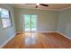 Bedroom features hardwood floors, a window, and sliding glass doors to the backyard at 3004 Bay Shore Cir, Sarasota, FL 34234