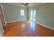 Bedroom features hardwood floors, ceiling fan, and sliding glass doors to the backyard at 3004 Bay Shore Cir, Sarasota, FL 34234