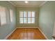 Bedroom features hardwood floors and plantation shutters at 3004 Bay Shore Cir, Sarasota, FL 34234