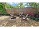 Fire pit area with chairs in a cozy backyard setting with gravel and landscaping at 3004 Bay Shore Cir, Sarasota, FL 34234