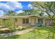 Lovely home featuring a well-maintained lawn, lush landscaping, and a stone walkway at 3004 Bay Shore Cir, Sarasota, FL 34234