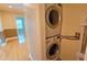Convenient laundry area featuring a stacked washer and dryer unit at 3004 Bay Shore Cir, Sarasota, FL 34234