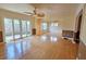 Bright living room features hardwood floors, ceiling fan, and sliding glass doors to the fenced-in backyard at 3004 Bay Shore Cir, Sarasota, FL 34234