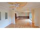 Open living room with hardwood floors, ceiling fans, and seamless flow to outdoor space via sliding doors at 3004 Bay Shore Cir, Sarasota, FL 34234