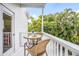 Private balcony with table and chairs overlooking lush tropical foliage at 316 64Th St, Holmes Beach, FL 34217