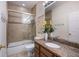 Bathroom featuring a tub and shower with a sliding glass door and tiled surround at 316 64Th St, Holmes Beach, FL 34217
