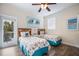 Comfortable bedroom featuring two twin beds, nautical decor, and access to a balcony at 316 64Th St, Holmes Beach, FL 34217