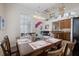 Bright dining room with a large window, modern lighting, and an open view to the living area on a second floor at 316 64Th St, Holmes Beach, FL 34217