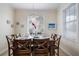 Cozy dining room features a wooden table set for six with natural light streaming through a window at 316 64Th St, Holmes Beach, FL 34217