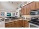 Modern kitchen boasts granite countertops, stainless steel appliances, and a breakfast bar open to a living room at 316 64Th St, Holmes Beach, FL 34217
