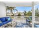 Relaxing screened patio features comfortable seating with views of the community and lush landscaping at 316 64Th St, Holmes Beach, FL 34217