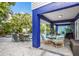 Covered outdoor patio with comfortable seating, dining area, and lush landscaping at 316 64Th St, Holmes Beach, FL 34217