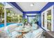 Stylish patio with comfortable seating, a ceiling fan, and poolside views at 316 64Th St, Holmes Beach, FL 34217