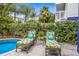 Inviting poolside with chaise lounges and tropical landscaping at 316 64Th St, Holmes Beach, FL 34217