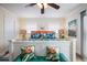 Coastal bedroom with flamingo decor, ceiling fan, and white trim at 316 64Th St, Holmes Beach, FL 34217